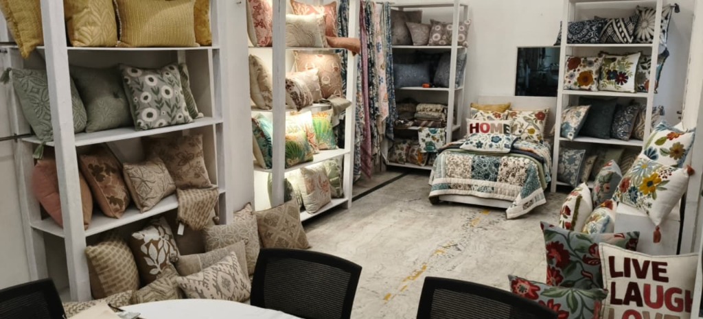 Showroom display shelves showing custom embroidered pillows